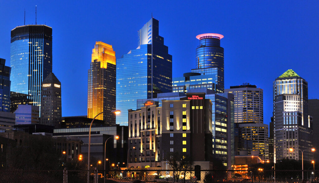 Minneapolis skyline at sunset featuring medical center buildings. Minneapolis skyline at sunset featuring medical center buildings.